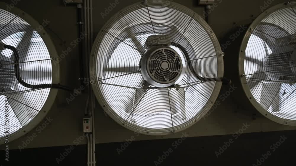 Working large industrial fans in a production area. Rotating fan blades.