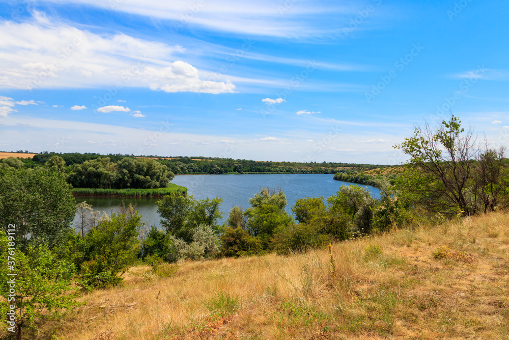 Summer landscape with beautiful river, green trees and blue sky