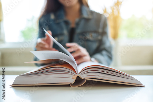 Closeup image of a woman sitting and reading book