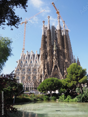 Cathedral under construction and pond in city of Barcelona in Spain