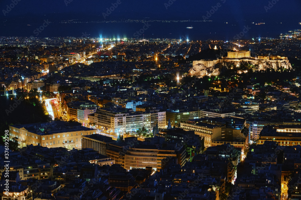 Night view of Athens and Acropolis, Parthenon and Erechtheion, Hellenic Parliament in city lights. Famous iconic view of UNESCO world heritage site.