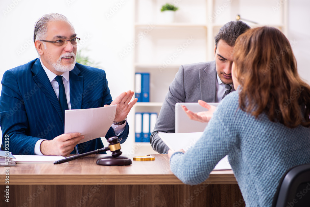 Young woman in courthouse with judge and lawyer Young woman in courthouse with judge and lawyer