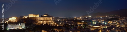 Iconic view of Acropolis hill in Athens, Greece at night. Delicate lights of Parthenon and Odeon theater. UNESCO world heritage. Night panorama.