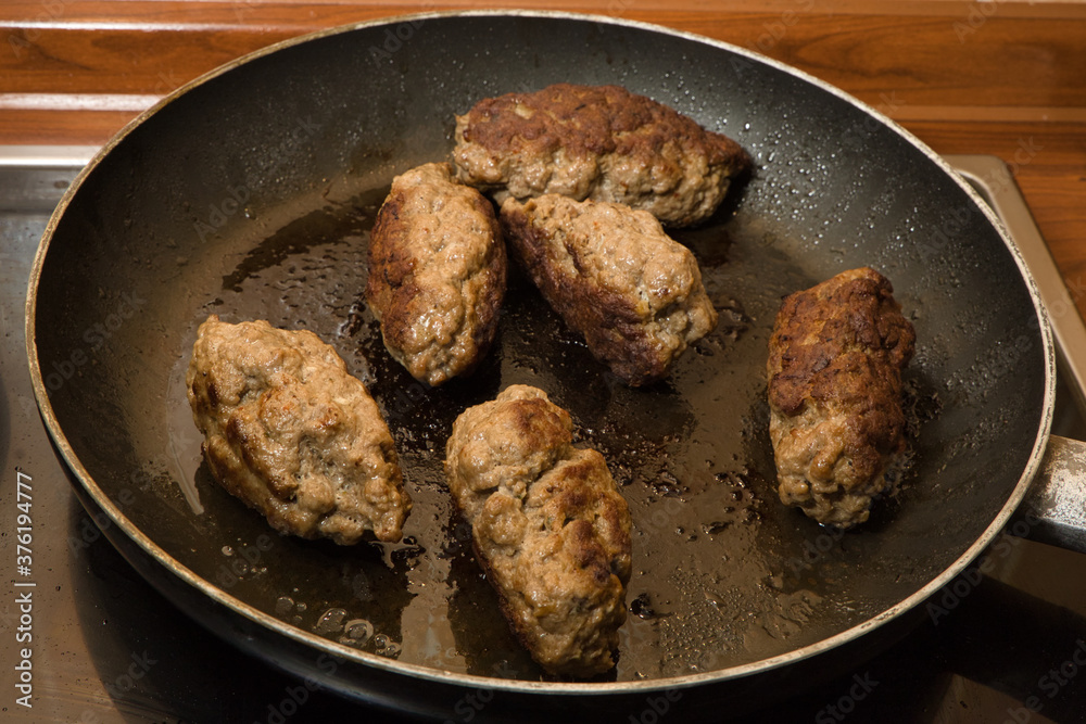 close up shot of cevapcici meat balls in a frying pan close up shot of cevapcici meat balls in a frying pan