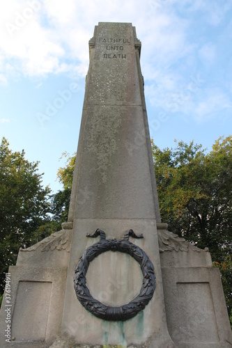 Upholland, Lancashire, UK, 06/09/2020: Close up of Upholland War Memorial grade 11 listed constructed from Portland Stone with a bronze wreath and inscribbed with the words faithful until death photo