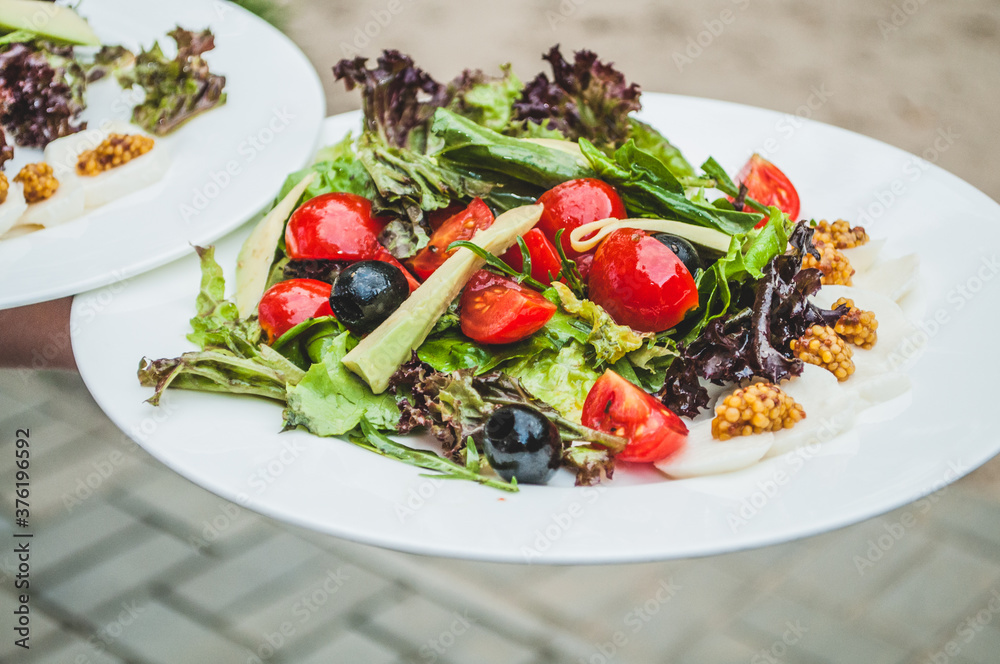 Serving the salad. Fine cuisine in a restaurant Serving the salad. Fine cuisine in a restaurant