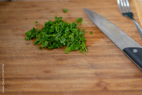 fresh, green, chopped parsley on a kitchen table board