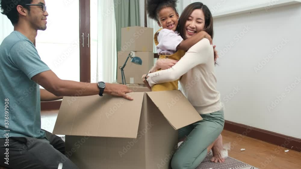 Happy asian women LGBT lesbian couple holding boxes entering new modern house.family unpacking boxes.little girl in the box, woman is surprised and happy to receive a surprise.couple happy time. Happy asian women LGBT lesbian couple holding boxes entering new modern house.family unpacking boxes.little girl in the box, woman is surprised and happy to receive a surprise.couple happy time.