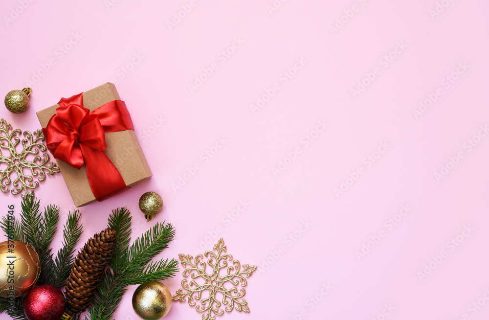 Beautiful composition. Christmas pink background with fir, christmas gifts and decor. Top view with space for copy.