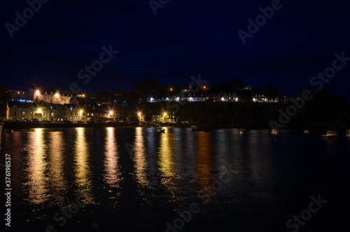 City landscape,of Portree at night with the lights of lamppost reflected on the sea water, Isle of Skye, United Kingdom © JMDuran Photography