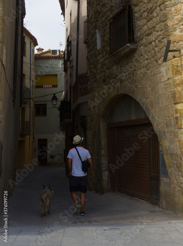 young man walking with his dog in Besalu