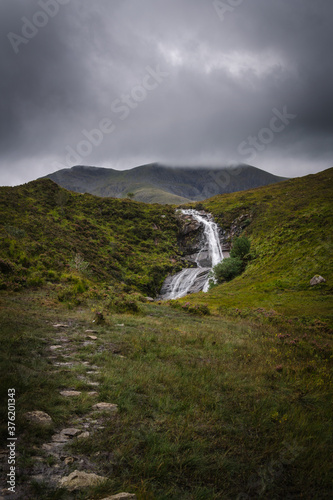 A nature landscape with a waterfall under a cloudy sky in the Isle of Skye  Scotland  United Kingdom