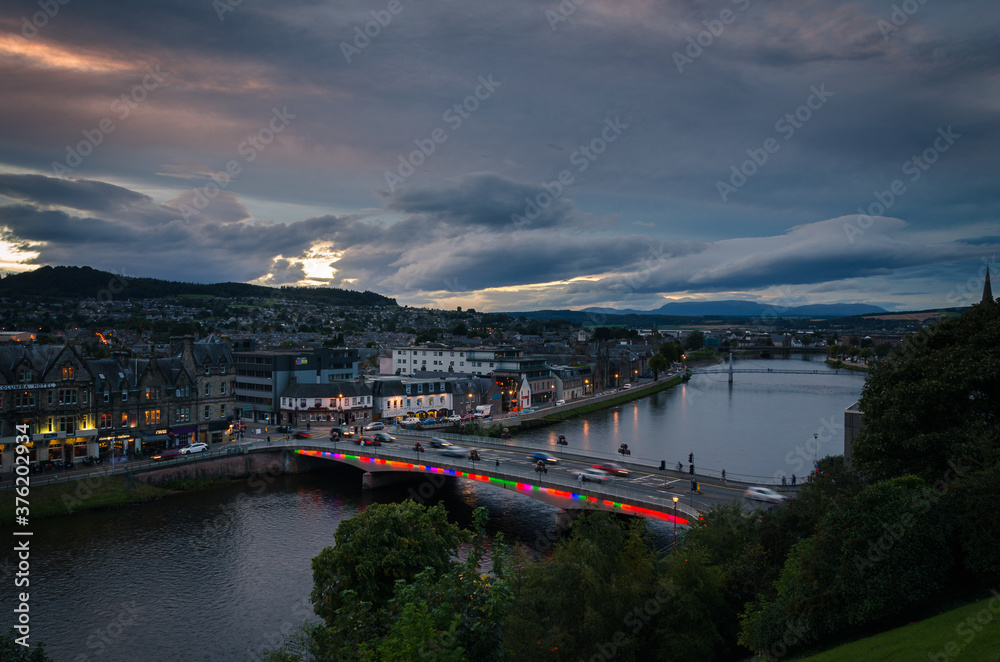 Inverness city landscape with the illumnated city and its reflection in the river Ness, Scotland, United Kingdom