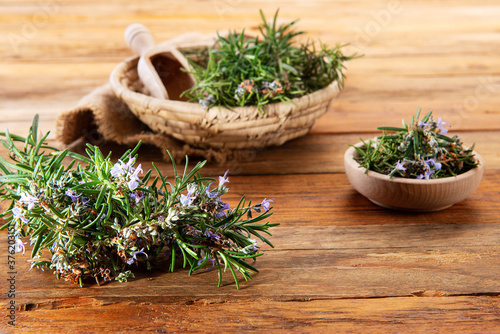 bunch of rosemary on a wooden table for alternative medicine