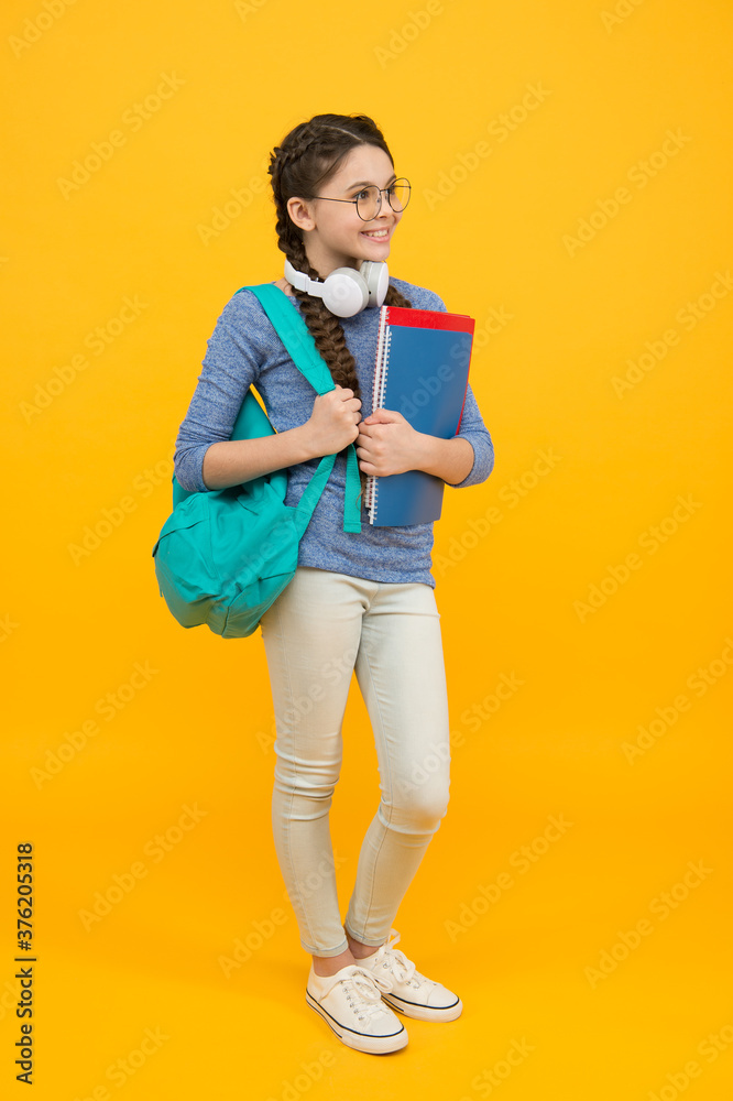 Modern technologies in education. Happy child back to school. Little girl wear headphones. Modern life. Music school. Modern learning. Language courses. English for kids Modern technologies in education. Happy child back to school. Little girl wear headphones. Modern life. Music school. Modern learning. Language courses. English for kids
