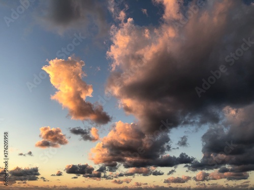 Beautiful clouded colores in pink by natural light from sunrise above sea © Marina