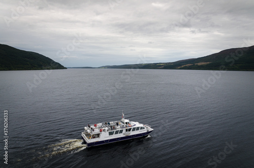 Tourist boat on the famous Loch Ness on a cloudy day, HIghland, Scotland