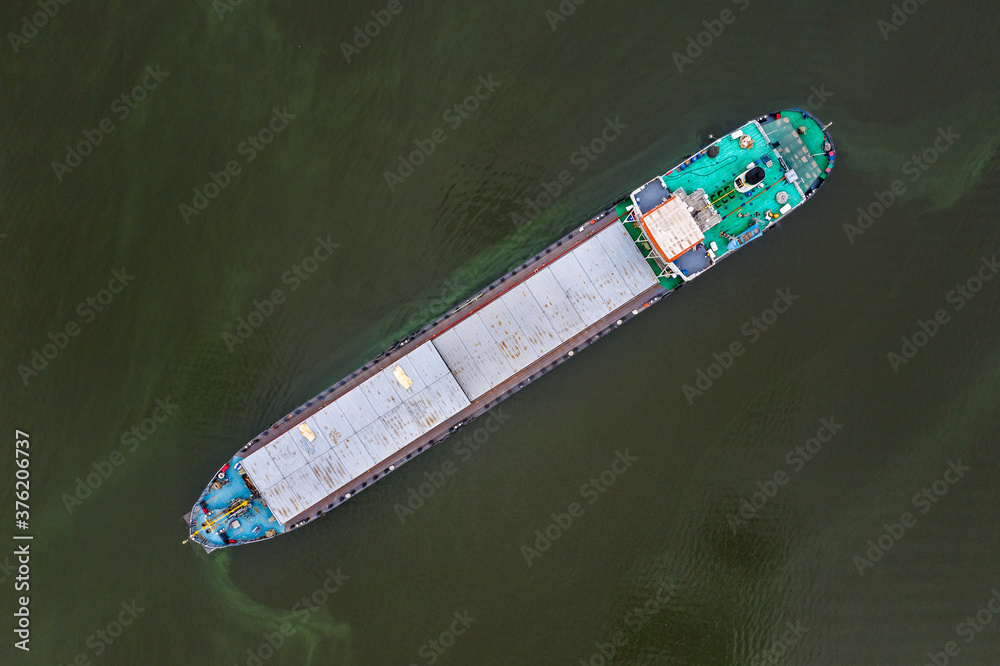 Top view of a dry cargo ship which is anchored in the Dnieper river near the port, awaiting unloading.