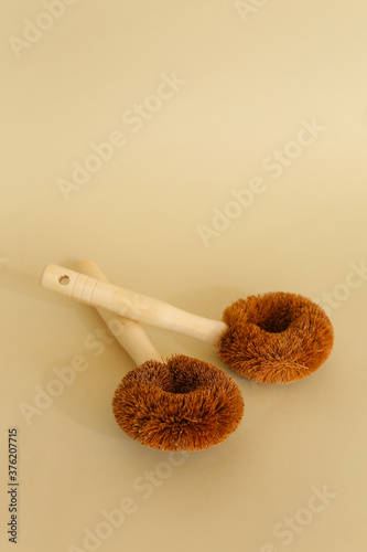 Two classic wooden dish brushes in light background with copy space. photo