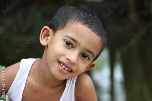 Close up of little cheerful asian boy child looking with cuteness on face  eyes ear nose mouth