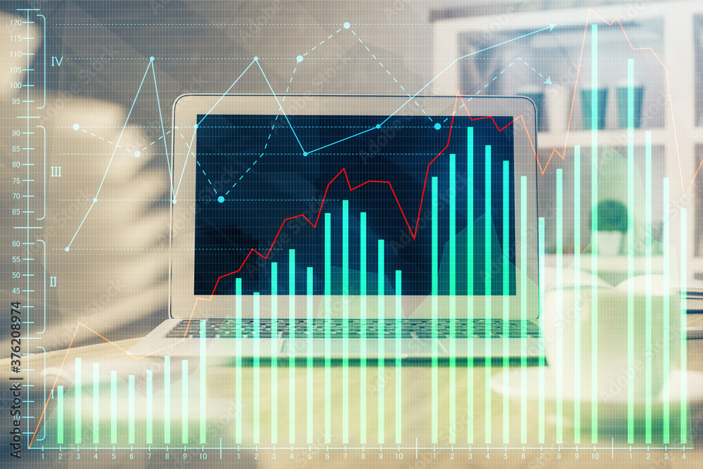 Financial graph colorful drawing and table with computer on background. Double exposure. Concept of international markets. Financial graph colorful drawing and table with computer on background. Double exposure. Concept of international markets.