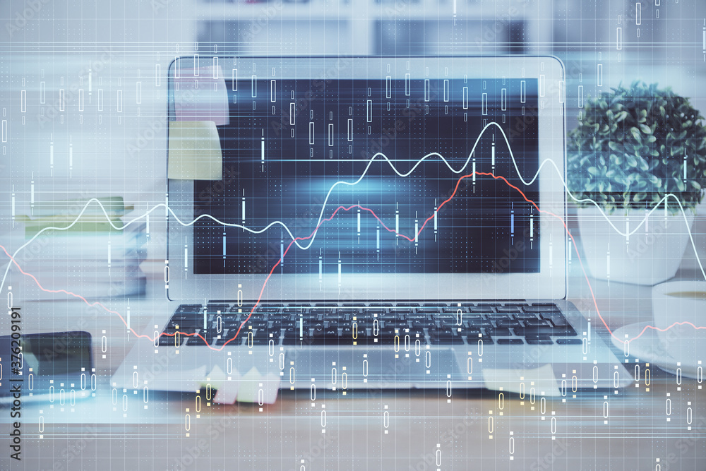 Financial chart drawing and table with computer on background. Double exposure. Concept of international markets. Financial chart drawing and table with computer on background. Double exposure. Concept of international markets.