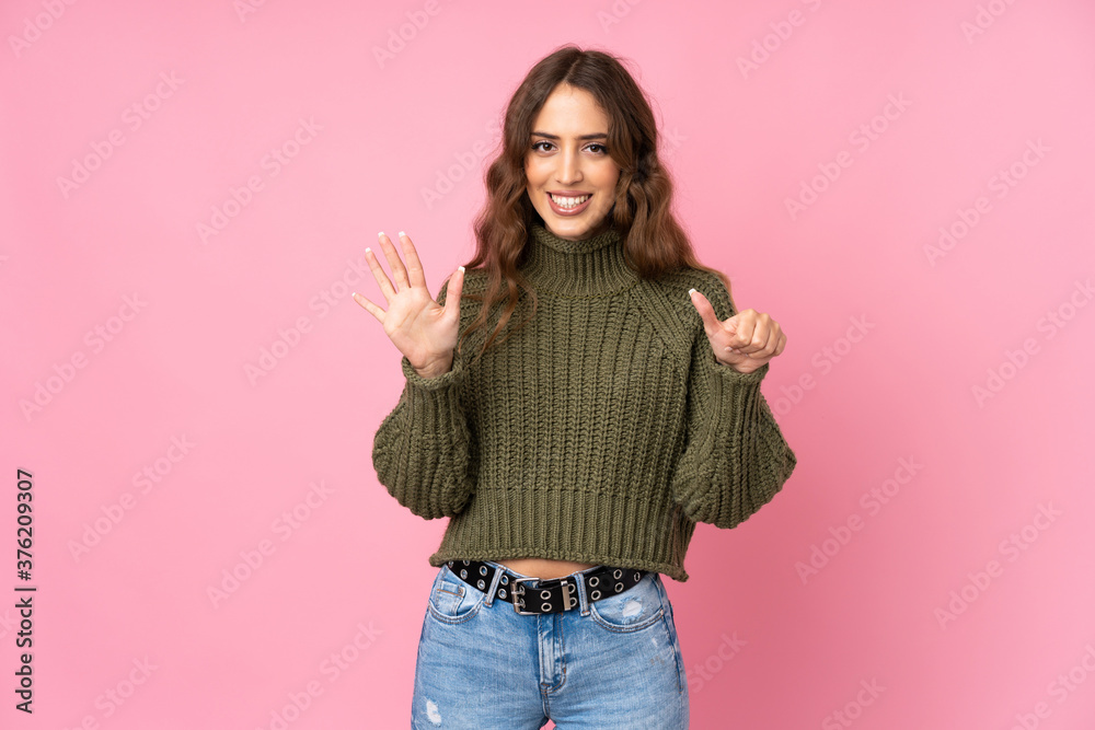 Young woman over isolated pink background counting six with fingers Young woman over isolated pink background counting six with fingers