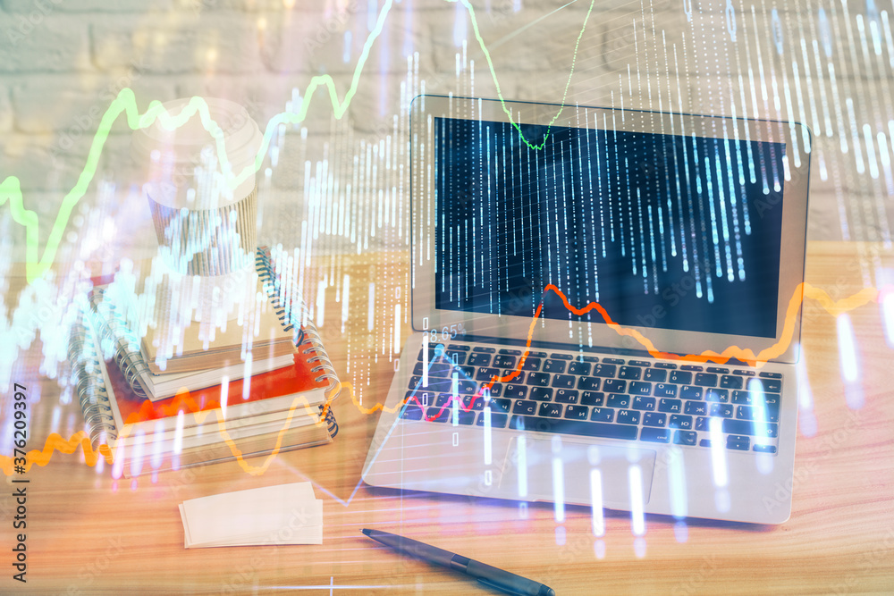 Financial graph colorful drawing and table with computer on background. Double exposure. Concept of international markets. Financial graph colorful drawing and table with computer on background. Double exposure. Concept of international markets.