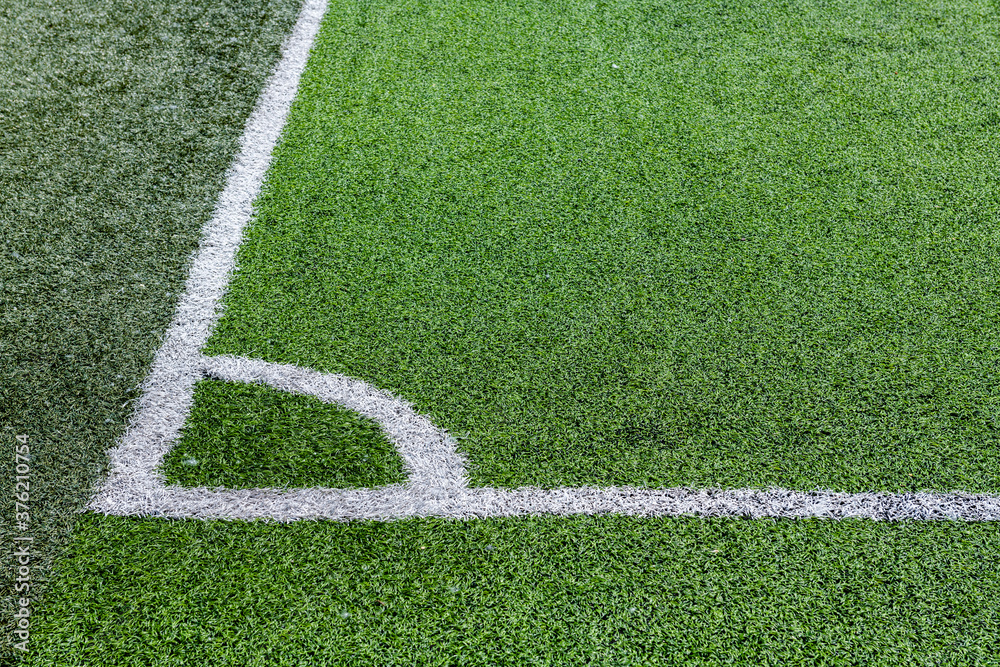 Nice close up shot of green artificial grass football pitch with corner markings 