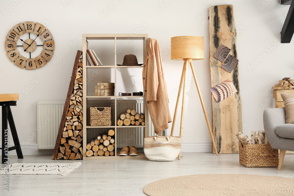Naklejka premium Stylish room interior with firewood as decorative element