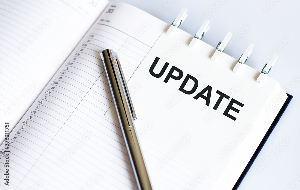 text UPDATE on the short note texture background with pen text UPDATE on the short note texture background with pen