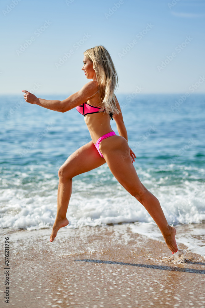 Fototapeta premium Beautiful woman in bikini over beach background.
