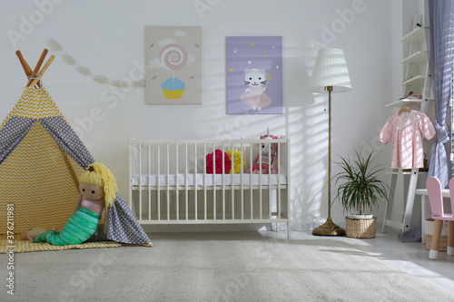 Fototapeta Naklejka Na Ścianę i Meble -  Baby room interior with cute posters, play tent and comfortable crib