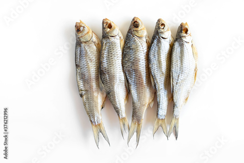 isolated close up top view dried salted caspian roach fish on a white background photo