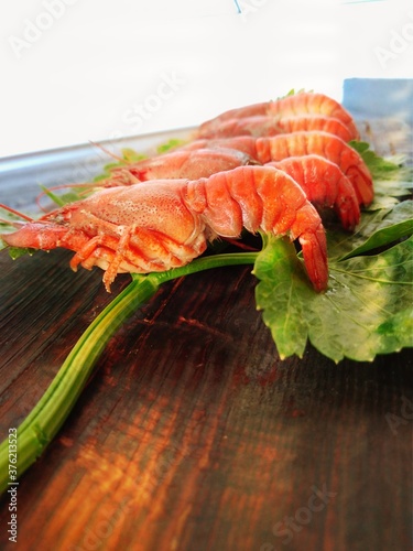  fresh crayfish served on a plate with celery leaf 