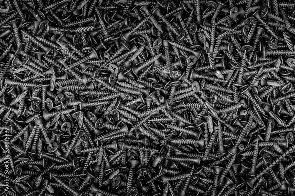 Textured background made of self-tapping screws in black and white. Textured background made of self-tapping screws in black and white.