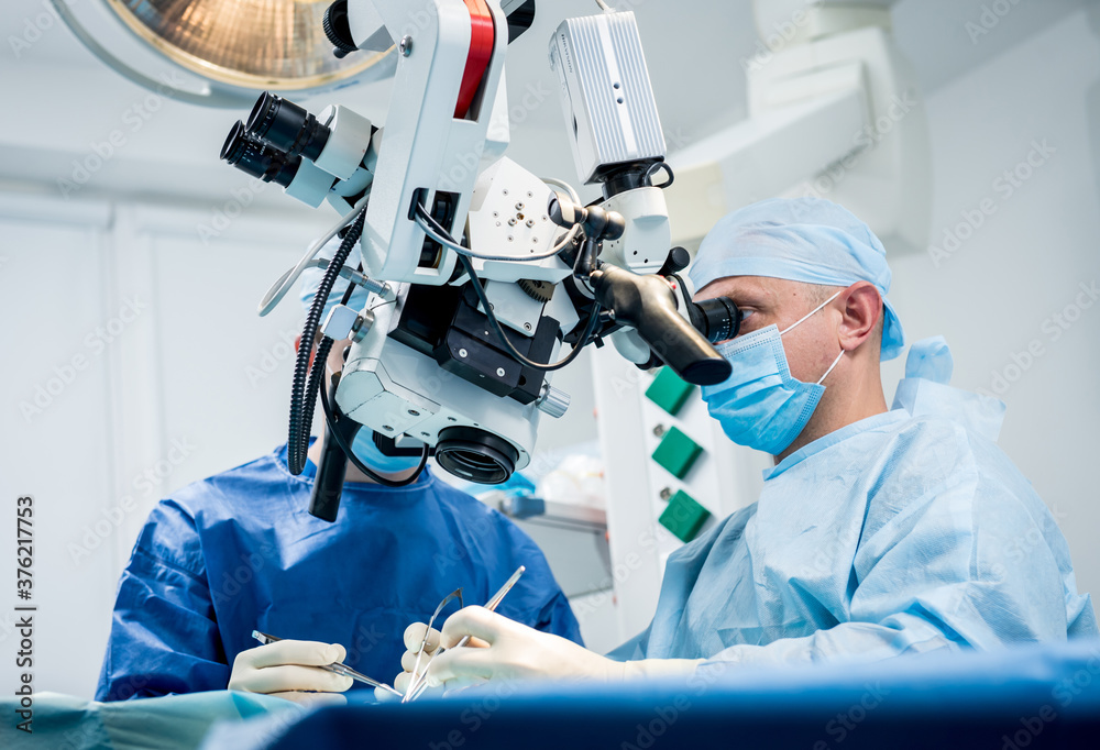 A team of surgeons performing brain surgery to remove a tumor. A team of surgeons performing brain surgery to remove a tumor.
