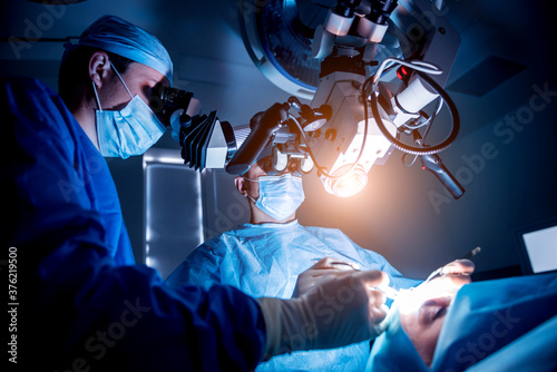 A team of surgeons performing brain surgery to remove a tumor. photo