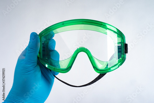 A hand in rubber gloves hol...