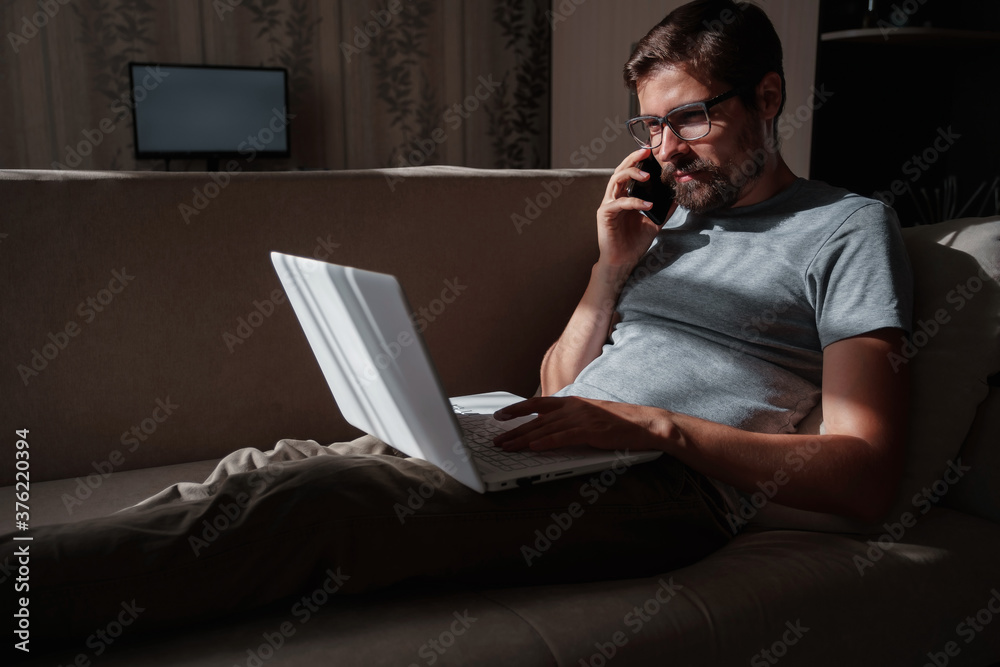 Smiling handsome freelancer working remotely from home. Smiling handsome freelancer working remotely from home.