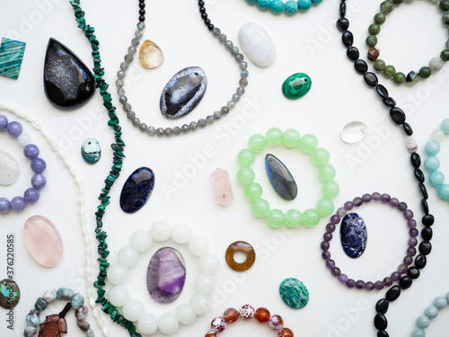 Multicolored semi-precious stones on a white background