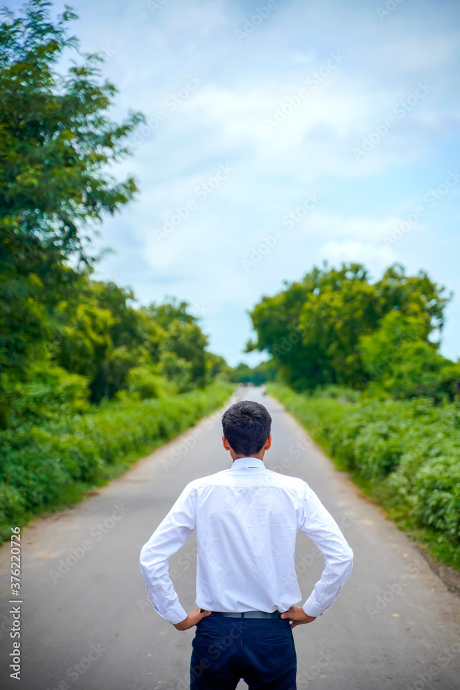 Young asian / Indian boy Standing on the road