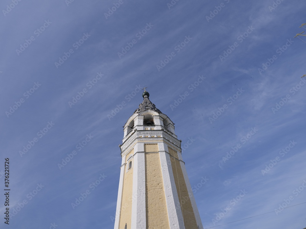 church steeple against blue sky with net of silver clouds church steeple against blue sky with net of silver clouds