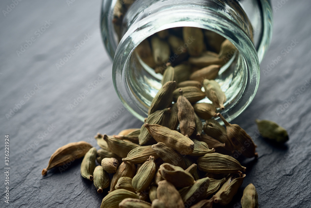 Cardamom sprinkled from a glass jar. Cardamom sprinkled from a glass jar.