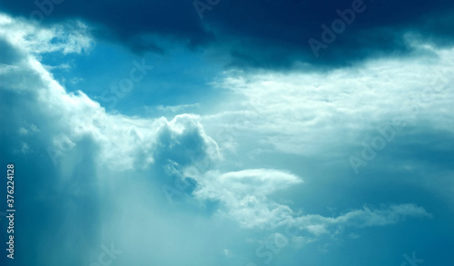 Dramatic dark blue sky with heavy clouds background.