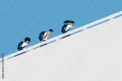 School children carrying bags walking up the stairs to the school 