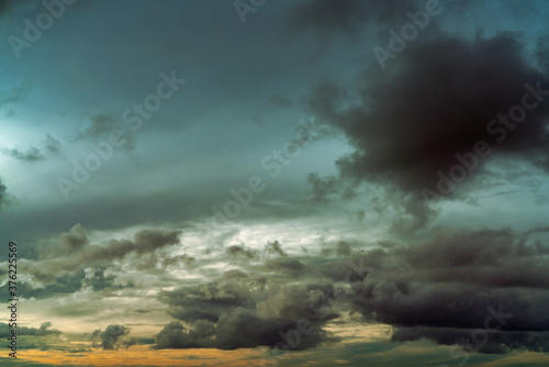 Sunset sky and gray and golden clouds. Gray sky and fluffy clouds. Thunder and storm sky. Sad and moody sky. Dead abstract background. Cloudscape. Peaceful and tranquil background. Beauty in nature.