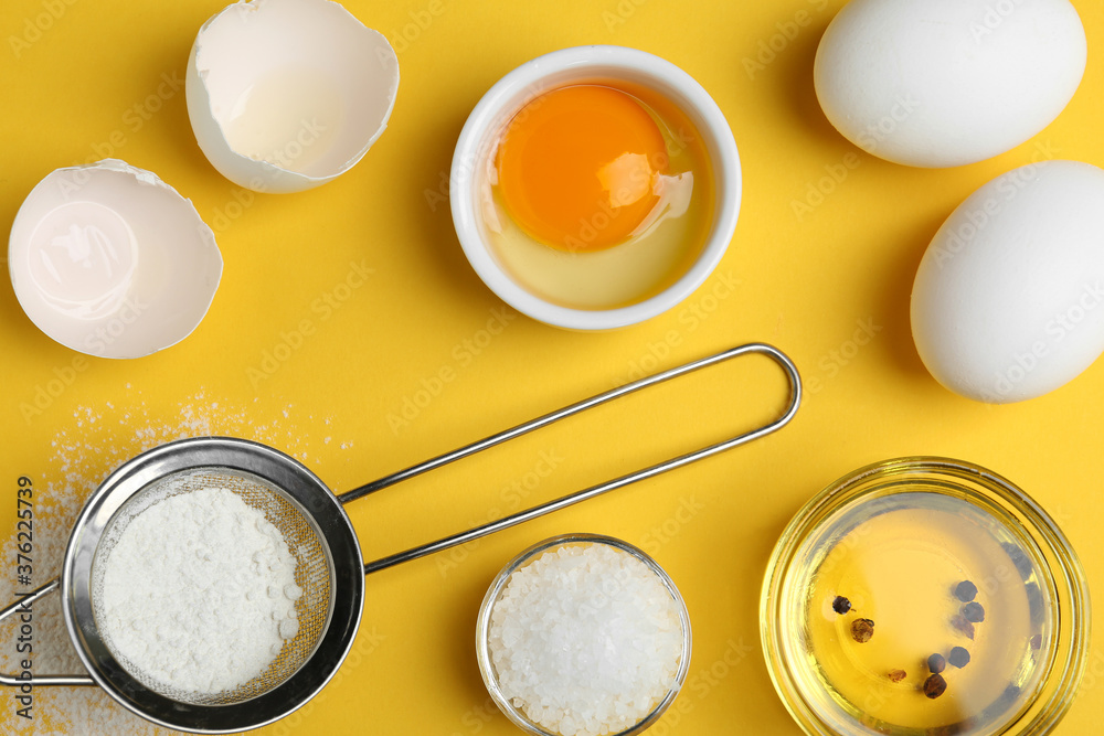 Flat lay composition with chicken eggs on yellow background Flat lay composition with chicken eggs on yellow background