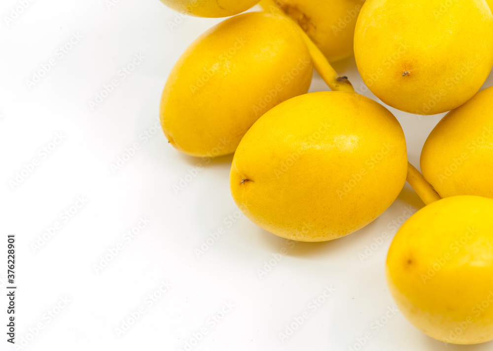 Macro organic fresh Date Palm fruit or Date fruit on white background. Date Palm fruit is on corner of art board frame. Macro organic fresh Date Palm fruit or Date fruit on white background. Date Palm fruit is on corner of art board frame.