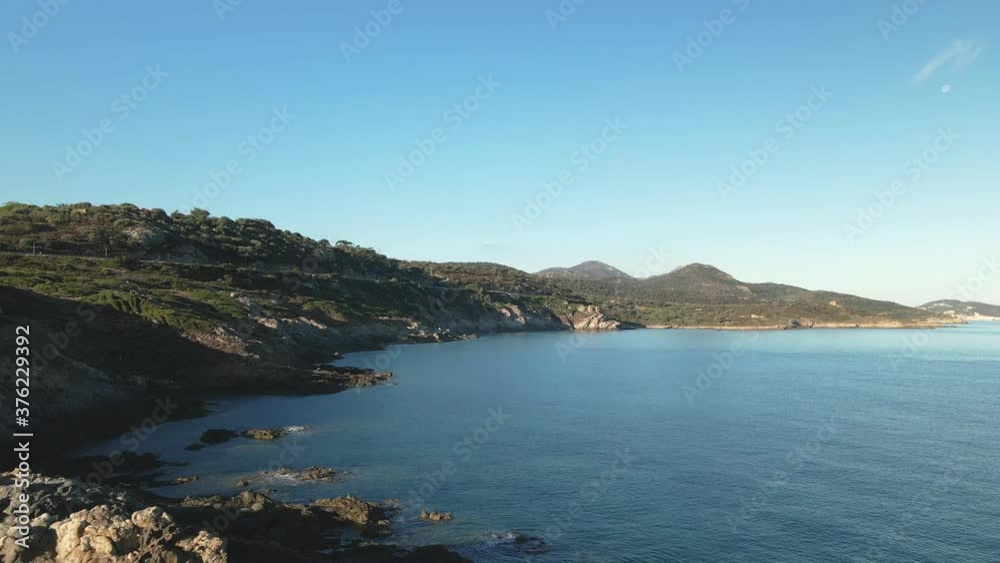 Drone view along the rocky coastline and Mediterranean sea of Corsica between Losari and Ile Rousse on a clear sunny morning